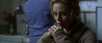 Movie still from “The Sea Inside” (2004), directed by Alejandro Amenábar – A woman with her hands clasped in front of her face; Close Up shot, Over the shoulder angle