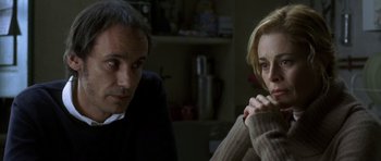 Movie still from “The Sea Inside” (2004), directed by Alejandro Amenábar – A man and a woman sitting next to each other in a room; Close Up shot, Over the shoulder angle