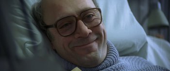 Movie still from “The Sea Inside” (2004), directed by Alejandro Amenábar – A person wearing glasses and smiling; Close Up shot, Low angle