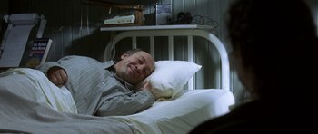 Movie still from “The Sea Inside” (2004), directed by Alejandro Amenábar – A man laying in a bed with a pillow; Medium shot, High angle