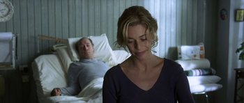 Movie still from “The Sea Inside” (2004), directed by Alejandro Amenábar – A man and a woman sitting in a hospital bed; Medium shot, Over the shoulder angle