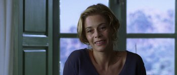 Movie still from “The Sea Inside” (2004), directed by Alejandro Amenábar – A person smiling near a window; Close Up shot, Over the shoulder angle