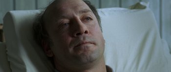 Movie still from “The Sea Inside” (2004), directed by Alejandro Amenábar – A person laying in a hospital bed; Close Up shot, High angle