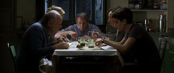 Movie still from “The Sea Inside” (2004), directed by Alejandro Amenábar – A group of people sitting at a table eating food; Medium shot, High angle