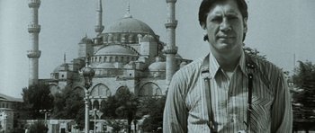 Movie still from “The Sea Inside” (2004), directed by Alejandro Amenábar – A man standing in front of a large building; Close Up shot, Low angle