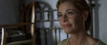 Movie still from “The Sea Inside” (2004), directed by Alejandro Amenábar – A woman's face in front of a metal gate; Close Up shot, Over the shoulder angle