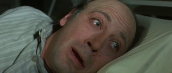 Movie still from “The Sea Inside” (2004), directed by Alejandro Amenábar – A person laying in a bed with his eyes wide open; Close Up shot, High angle