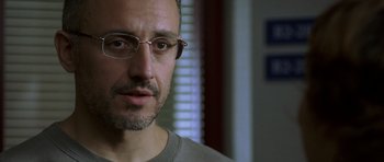 Movie still from “The Sea Inside” (2004), directed by Alejandro Amenábar – A person wearing glasses and a gray shirt; Close Up shot, Low angle