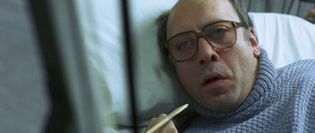 Movie still from “The Sea Inside” (2004), directed by Alejandro Amenábar – A man with glasses is laying in bed and holding a pen; Close Up shot, Overhead angle