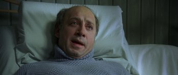 Movie still from “The Sea Inside” (2004), directed by Alejandro Amenábar – A man laying in a hospital bed looking sad; Close Up shot, High angle