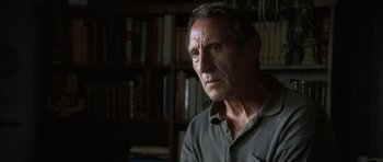 Movie still from “The Sea Inside” (2004), directed by Alejandro Amenábar – A person in a room with a book shelf in the background; Close Up shot, Low angle