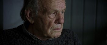 Movie still from “The Sea Inside” (2004), directed by Alejandro Amenábar – An old man with a sad look on his face; Close Up shot, Low angle