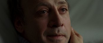 Movie still from “The Sea Inside” (2004), directed by Alejandro Amenábar – A man's face with a hand touching his ear; Close Up shot, Low angle