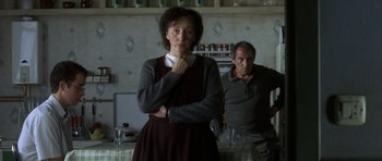 Movie still from “The Sea Inside” (2004), directed by Alejandro Amenábar – An older woman standing next to a man in a kitchen; Medium shot, Low angle