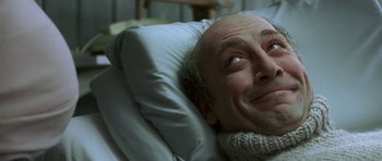 Movie still from “The Sea Inside” (2004), directed by Alejandro Amenábar – An older man laying in a hospital bed with his eyes wide open; Close Up shot, Low angle