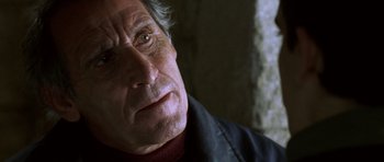 Movie still from “The Sea Inside” (2004), directed by Alejandro Amenábar – An older man with a beard and a black jacket; Close Up shot, Over the shoulder angle