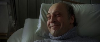 Movie still from “The Sea Inside” (2004), directed by Alejandro Amenábar – An older man smiling while laying in a hospital bed; Close Up shot, Low angle