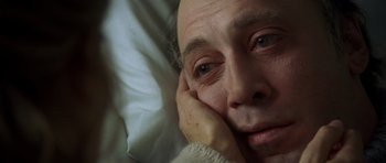 Movie still from “The Sea Inside” (2004), directed by Alejandro Amenábar – An older man laying in bed with his hand on his face; Close Up shot, High angle