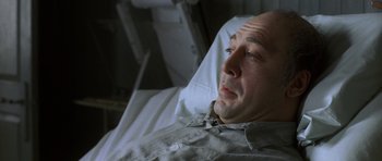 Movie still from “The Sea Inside” (2004), directed by Alejandro Amenábar – A man laying in a hospital bed looking sad; Close Up shot, High angle
