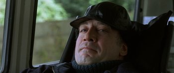 Movie still from “The Sea Inside” (2004), directed by Alejandro Amenábar – A person wearing a hat and jacket; Close Up shot, Low angle