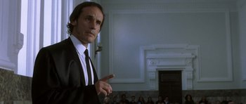 Movie still from “The Sea Inside” (2004), directed by Alejandro Amenábar – A man in a suit and tie standing in front of an audience; Close Up shot, Low angle