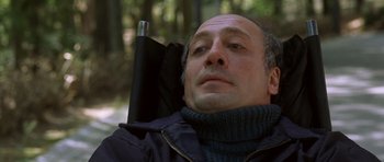 Movie still from “The Sea Inside” (2004), directed by Alejandro Amenábar – A bald man with a beard and a jacket on; Close Up shot, High angle