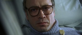 Movie still from “The Sea Inside” (2004), directed by Alejandro Amenábar – A person wearing glasses and a sweater; Close Up shot, Low angle