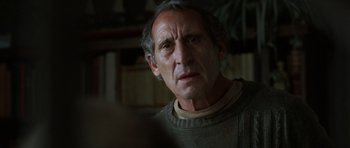 Movie still from “The Sea Inside” (2004), directed by Alejandro Amenábar – An older man wearing a sweater looking at the camera; Close Up shot, Over the shoulder angle