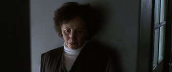 Movie still from “The Sea Inside” (2004), directed by Alejandro Amenábar – An older woman is standing against a wall; Close Up shot, Low angle