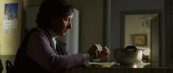 Movie still from “The Sea Inside” (2004), directed by Alejandro Amenábar – A person sitting at a table with a bowl of food; Close Up shot, Over the shoulder angle