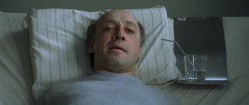 Movie still from “The Sea Inside” (2004), directed by Alejandro Amenábar – A person laying in a hospital bed; Close Up shot, High angle