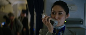 Movie still from “The Sea of Trees” (2015), directed by Gus Van Sant – A woman holding a phone up to her ear; Close Up shot, High angle