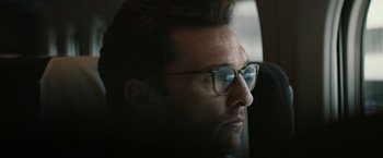 Movie still from “The Sea of Trees” (2015), directed by Gus Van Sant – A person wearing glasses looking out of a window; Close Up shot, Low angle