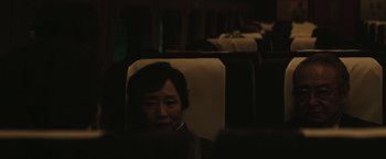 Movie still from “The Sea of Trees” (2015), directed by Gus Van Sant – A woman sitting on a train looking out of the window; Close Up shot, High angle