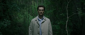 Movie still from “The Sea of Trees” (2015), directed by Gus Van Sant – A man wearing glasses standing in the middle of a forest; Close Up shot, Low angle