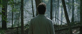 Movie still from “The Sea of Trees” (2015), directed by Gus Van Sant – A man standing in the middle of a forest; Close Up shot, Over the shoulder angle