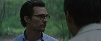 Movie still from “The Sea of Trees” (2015), directed by Gus Van Sant – A man wearing glasses talking to another man outside; Close Up shot, Over the shoulder angle