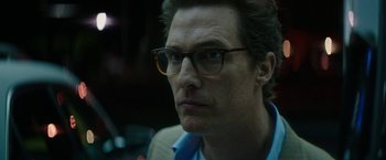 Movie still from “The Sea of Trees” (2015), directed by Gus Van Sant – A person wearing glasses; Close Up shot, Low angle