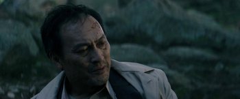 Movie still from “The Sea of Trees” (2015), directed by Gus Van Sant – A person wearing a suit and tie; Close Up shot, Low angle