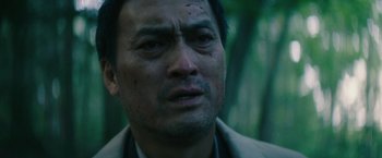 Movie still from “The Sea of Trees” (2015), directed by Gus Van Sant – A person wearing a jacket; Close Up shot, Low angle
