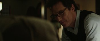 Movie still from “The Sea of Trees” (2015), directed by Gus Van Sant – A person wearing glasses looking at something; Close Up shot, Over the shoulder angle
