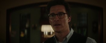 Movie still from “The Sea of Trees” (2015), directed by Gus Van Sant – A person wearing glasses and a jacket; Close Up shot, Over the shoulder angle
