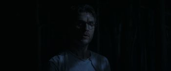 Movie still from “The Sea of Trees” (2015), directed by Gus Van Sant – A man with glasses is standing in the dark; Close Up shot, Low angle