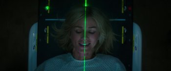 Movie still from “The Sea of Trees” (2015), directed by Gus Van Sant – A woman with a green light shining on her face; Close Up shot, Overhead angle