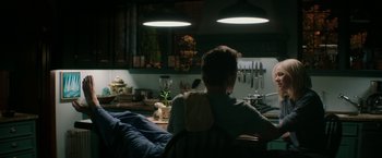 Movie still from “The Sea of Trees” (2015), directed by Gus Van Sant – A person sitting at a table in a kitchen; Medium shot, Over the shoulder angle