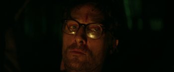 Movie still from “The Sea of Trees” (2015), directed by Gus Van Sant – A person wearing glasses; Close Up shot, Low angle