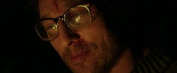 Movie still from “The Sea of Trees” (2015), directed by Gus Van Sant – A person wearing glasses; Extreme Close Up shot, Over the shoulder angle