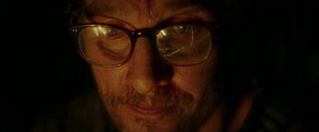Movie still from “The Sea of Trees” (2015), directed by Gus Van Sant – A person wearing glasses; Extreme Close Up shot, High angle