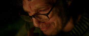 Movie still from “The Sea of Trees” (2015), directed by Gus Van Sant – A person wearing glasses with blood all over his face; Extreme Close Up shot, Low angle
