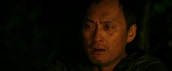 Movie still from “The Sea of Trees” (2015), directed by Gus Van Sant – A person looking at the camera; Close Up shot, Over the shoulder angle